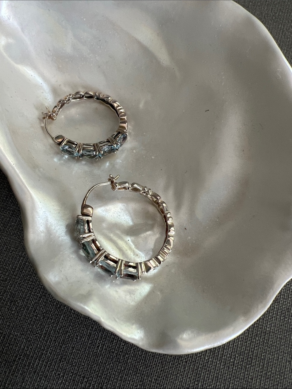 Silver Hoop Earrings with Light Blue  
topaz Gem Accents
